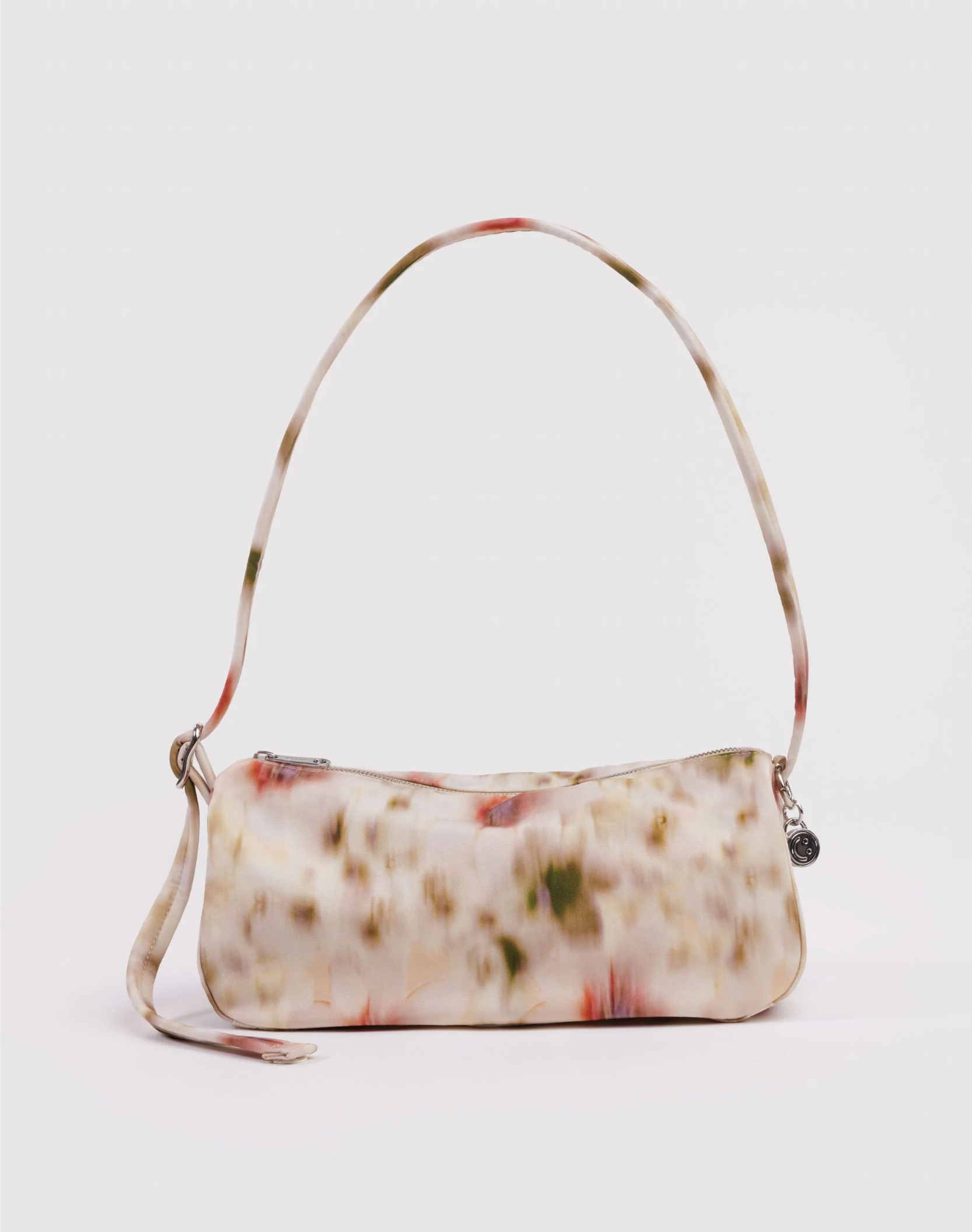 Abstract floral patterned handbag with a strap on a light gray background
