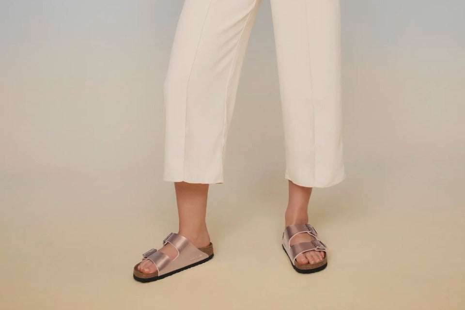 model wearing copper Arizona sandals