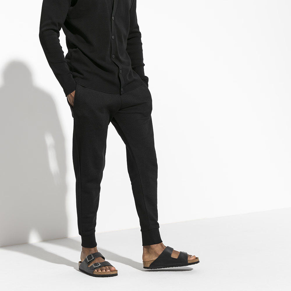 Birkenstock Arizona Soft Footbed Black Oiled Leather Two Strap Slip On Sandal Slide, light brown cork footbed with dark brown sole | Person wearing it view | Simons Shoes 