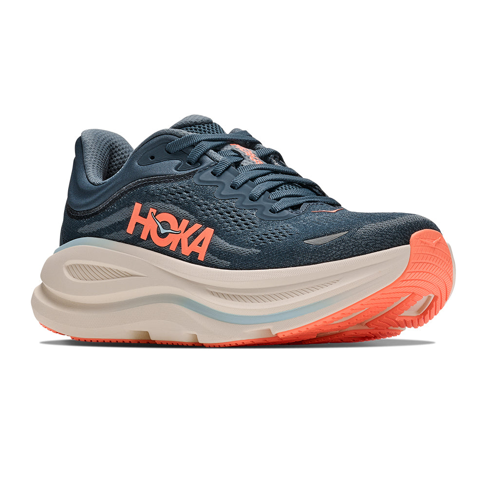 A HOKA Women's Bondi 9 running shoe in navy blue with a thick beige midsole and bright orange accents on the logo, tongue, and outsole, shown against a plain white background.