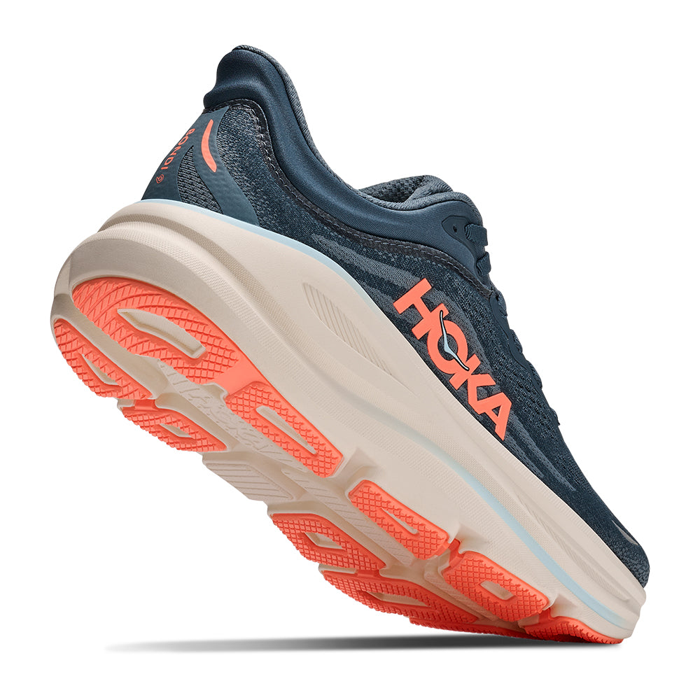 A HOKA Women's Bondi 9 running shoe in navy blue with a thick beige midsole and bright orange accents on the logo, tongue, and outsole, shown against a plain white background.