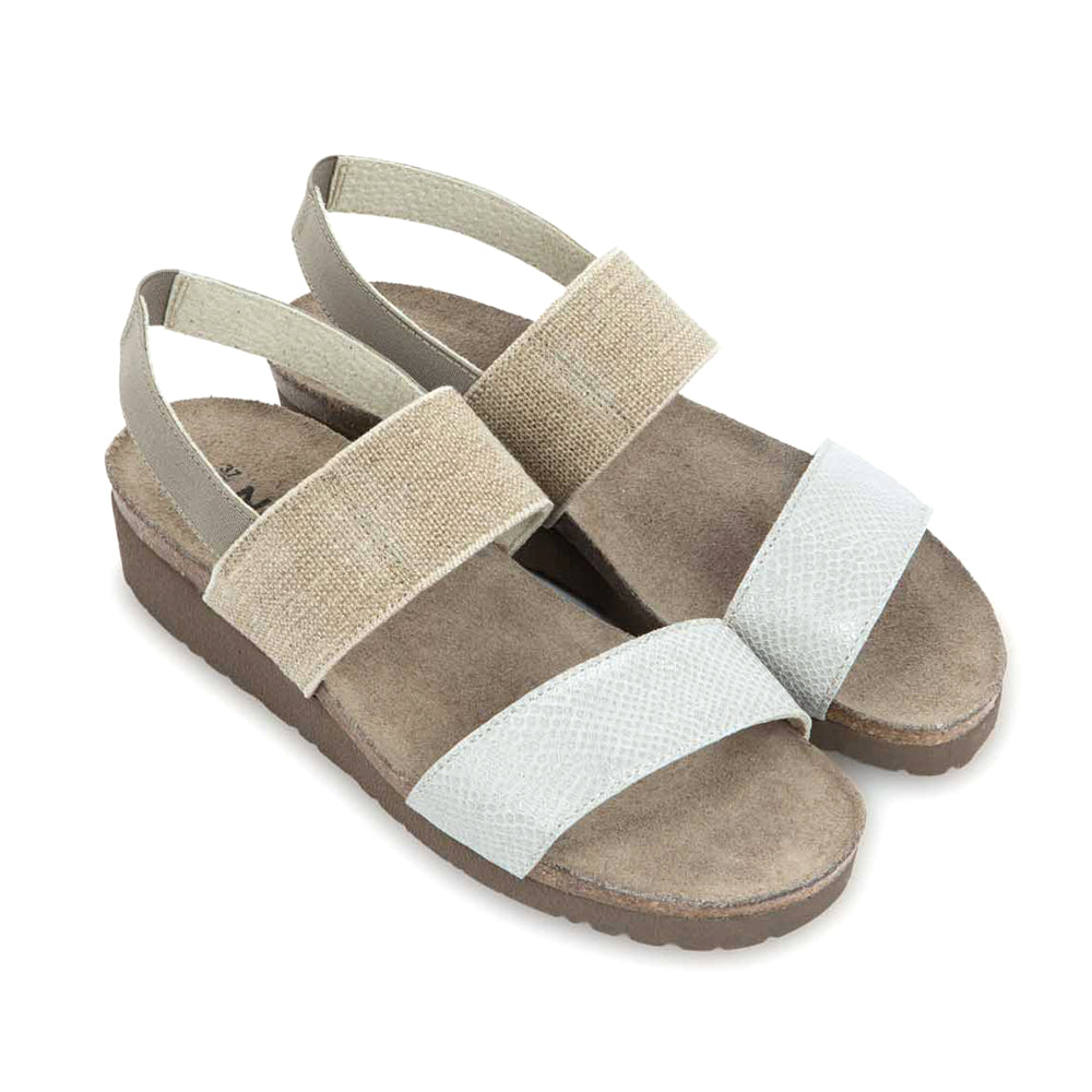Naot Amy Sandal with stretch strap around the ankle and top of foot, and single strap above the toe. Ankle strap is beige and toe strap is white leather. Footbed is brown and sole is darker brown. | Side view | Simons Shoes