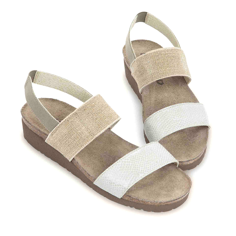 Naot Amy Sandal with stretch strap around the ankle and top of foot, and single strap above the toe. Ankle strap is beige and toe strap is white leather. Footbed is brown and sole is darker brown. | Side view | Simons Shoes
