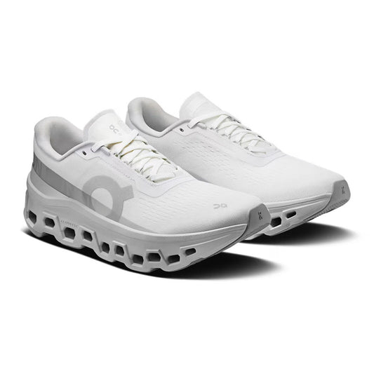 On Running Cloudmonster 1 Sneaker, white and white color way, all white except slight grey stripe on the side with the logo, sole is a grey color and bottom of shoe is a darker grey | Side view | Simons Shoes 